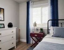 Secondary bedroom in the Aurora showhome by Alquinn Homes in Woodbend, Leduc.